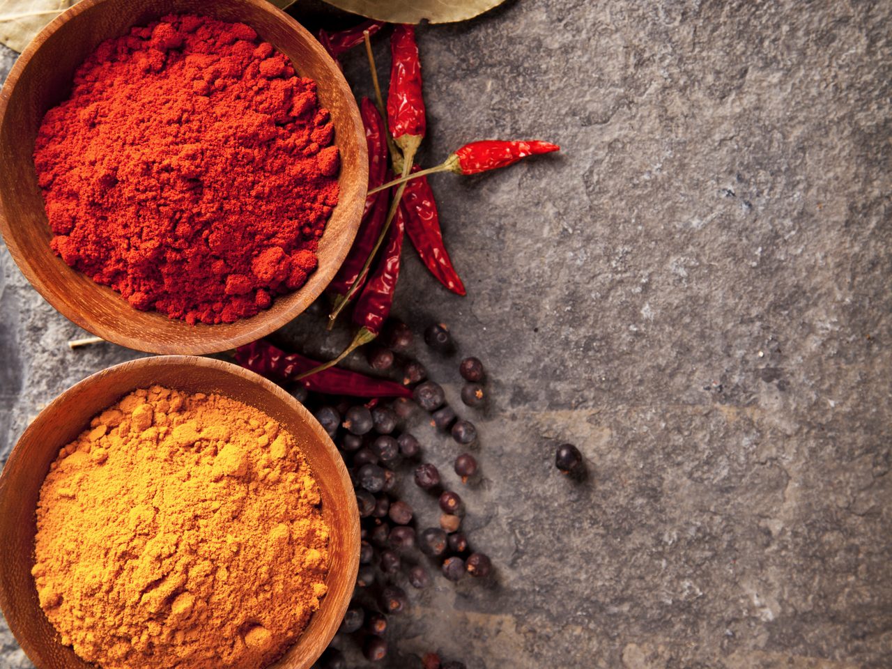 Bowls of colorful spices used in House of Spice catering and restaurant operations